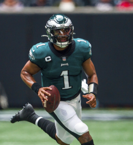 Jalen Hurts, quarterback for the Eagles, runs with the ball 