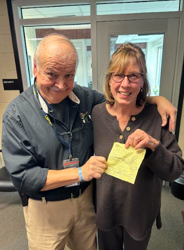 John Chapman and Andrea Schill pose with a speeding ticket.