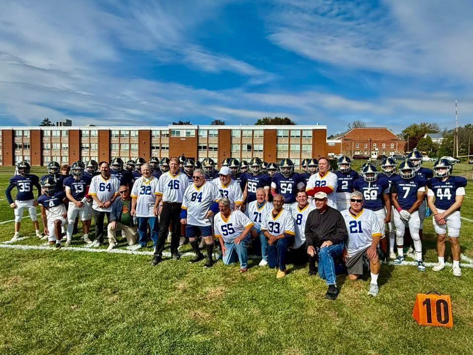 Class of 1975 Football Team with Current Football Team at Lower Moreland Homecoming Game
